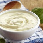 Homemade lactonesa, an egg free mayonnaise made with milk and olive oil, in a jar