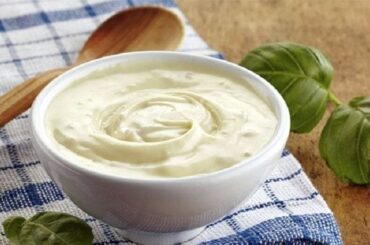Homemade lactonesa, an egg free mayonnaise made with milk and olive oil, in a jar