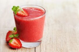 Glasses of fresh homemade strawberry juice with ice