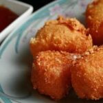 Breaded fried camembert wedges with sweet and sour sauce