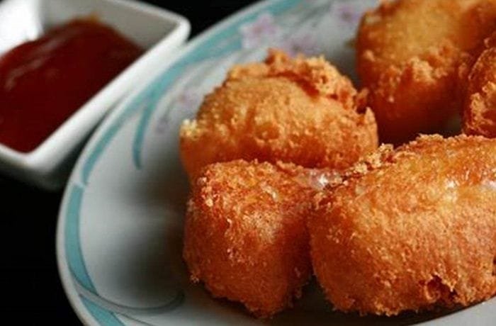 Breaded fried camembert wedges with sweet and sour sauce