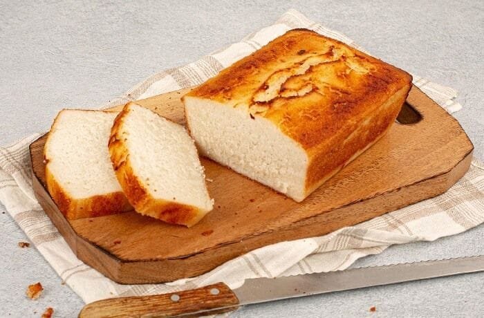 Fluffy gluten free rice flour bread baked in a loaf pan and sliced