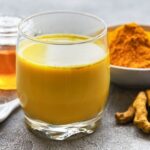 Golden milk, a warm turmeric latte with cinnamon, served in a cup
