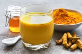 Golden milk, a warm turmeric latte with cinnamon, served in a cup