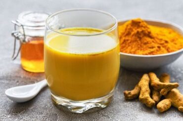 Golden milk, a warm turmeric latte with cinnamon, served in a cup