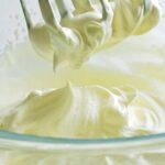 Homemade Chantilly whipped cream in a bowl with a whisk