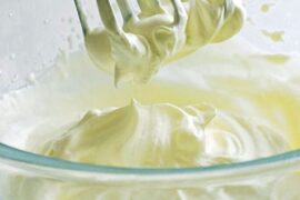 Homemade Chantilly whipped cream in a bowl with a whisk