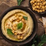 Homemade chickpea hummus with olive oil and paprika