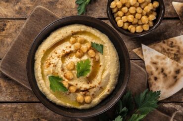 Homemade chickpea hummus with olive oil and paprika