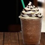 Homemade blended iced coffee frappuccino topped with whipped cream and chocolate sauce