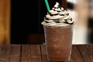 Homemade blended iced coffee frappuccino topped with whipped cream and chocolate sauce