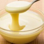Homemade sweetened condensed milk in a jar