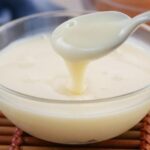 Homemade evaporated milk in a glass jar