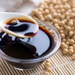 Homemade fermented soy sauce in a glass jar