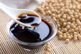 Homemade fermented soy sauce in a glass jar