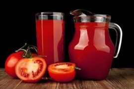 Glass of fresh homemade tomato juice with ice