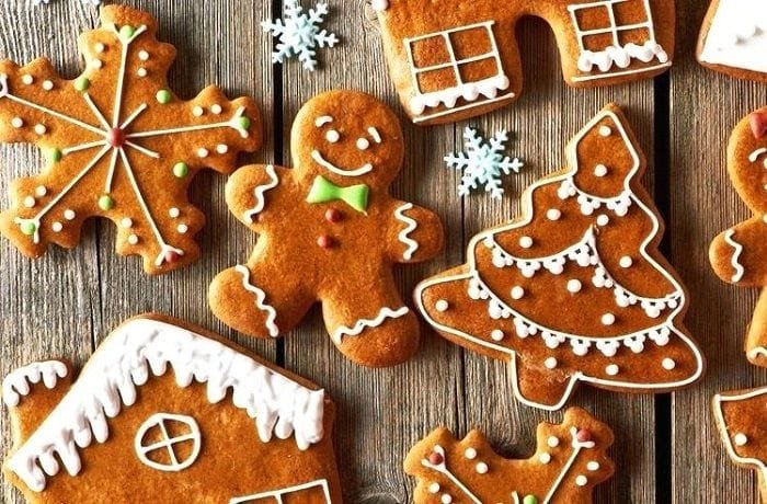 Homemade gingerbread cookies cut into Christmas shapes and decorated with icing
