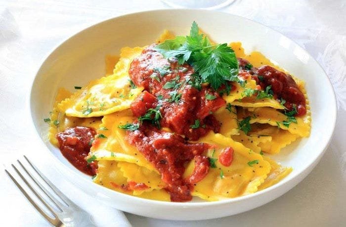 Homemade ravioli filled with ham, ricotta, and cheese