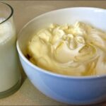 Bowl of homemade heavy cream made from milk and butter