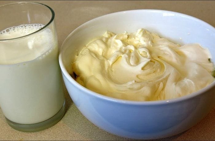 Bowl of homemade heavy cream made from milk and butter