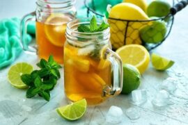 Homemade iced tea with lemon slices and mint