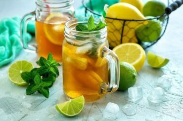 Homemade iced tea with lemon slices and mint