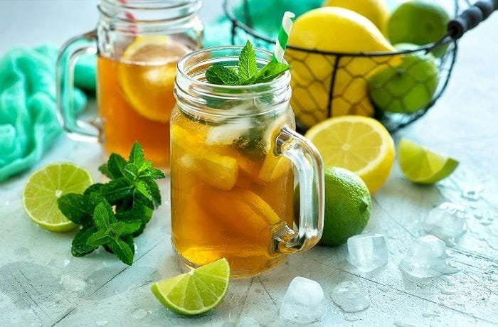 Homemade iced tea with lemon slices and mint