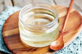 Homemade invert sugar syrup in a glass jar