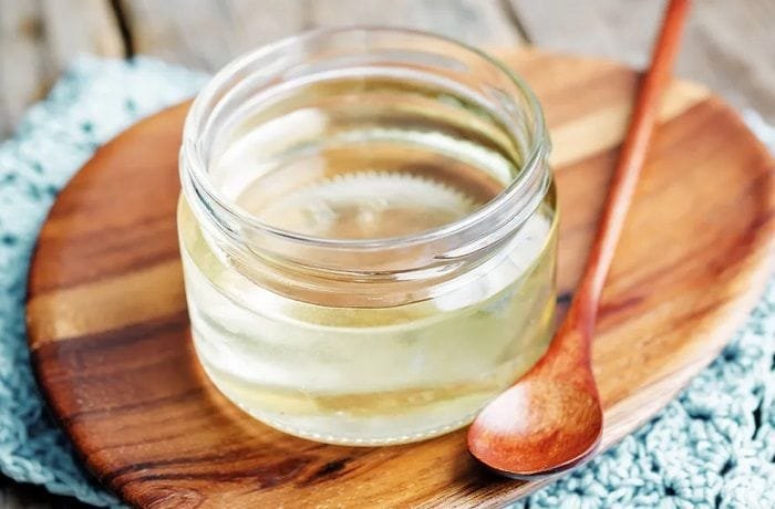 Homemade invert sugar syrup in a glass jar