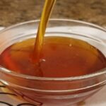 Homemade liquid caramel in a glass jar, ready for flan and desserts