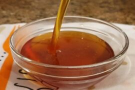 Homemade liquid caramel in a glass jar, ready for flan and desserts