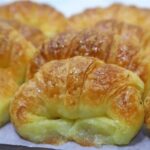 Homemade medialunas, glossy sweet South American croissants
