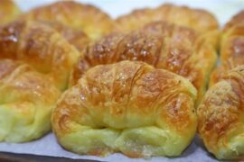 Homemade medialunas, glossy sweet South American croissants