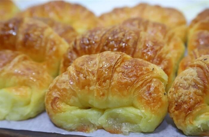 Homemade medialunas, glossy sweet South American croissants