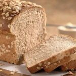 Homemade oat bread loaf topped with rolled oats