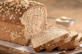 Homemade oat bread loaf topped with rolled oats