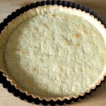 Homemade shortcrust quiche base pressed into a tart pan
