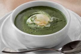 Homemade spinach soup with sour cream and Parmesan