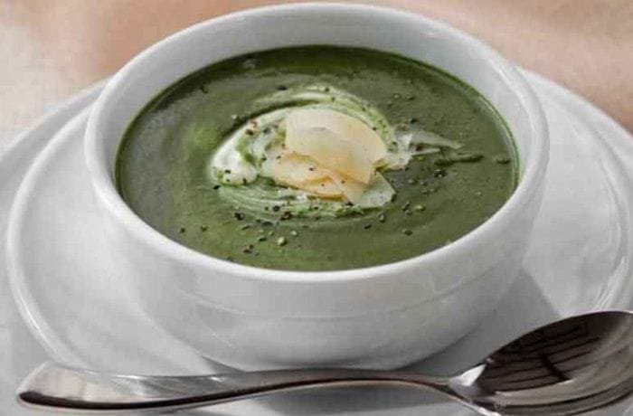 Homemade spinach soup with sour cream and Parmesan