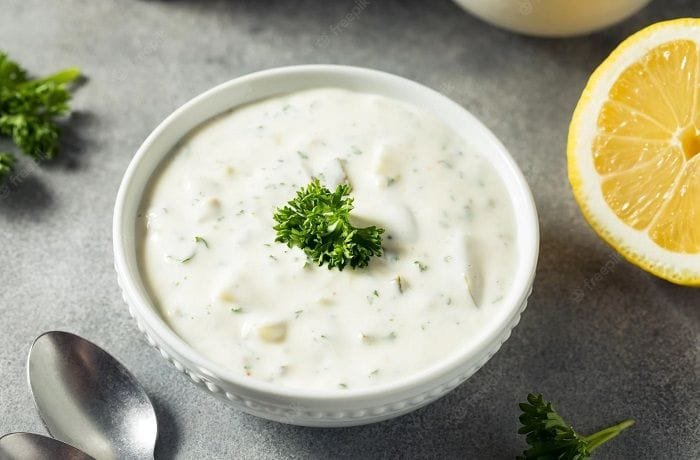 Homemade tartar sauce with mayonnaise, pickles, onion, and parsley