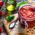 Homemade tomato sauce in a jar, made with peeled tomatoes, onion, and garlic