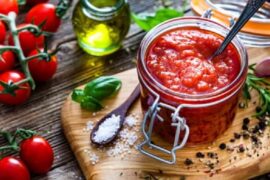 Homemade tomato sauce in a jar, made with peeled tomatoes, onion, and garlic