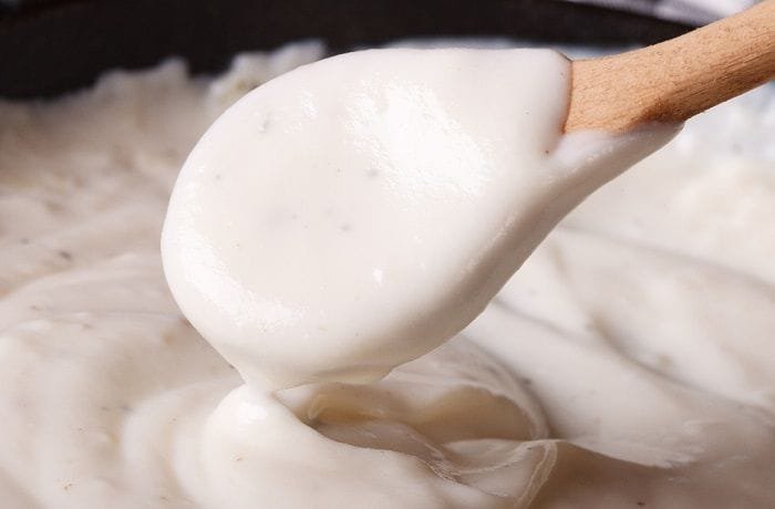 Homemade white sauce bechamel in a pot