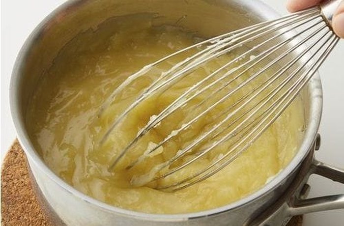 Thick lemon cream of condensed milk and lemon juice poured over the baked pie crust