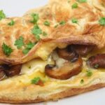 Folded mushroom omelette with parsley