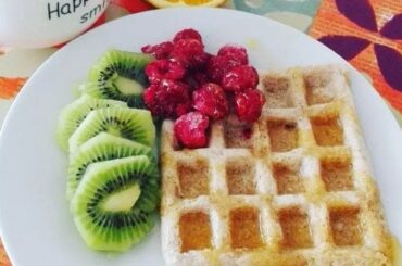 Oatmeal waffles served with fresh fruit and cream