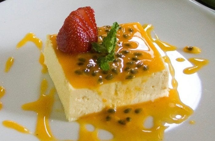 Passion fruit mousse in dessert cups topped with fresh passion fruit pulp