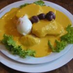 Papas a la huancaína with hard-boiled egg, botija olives and lettuce