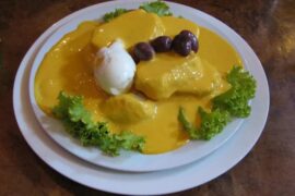 Papas a la huancaína with hard-boiled egg, botija olives and lettuce