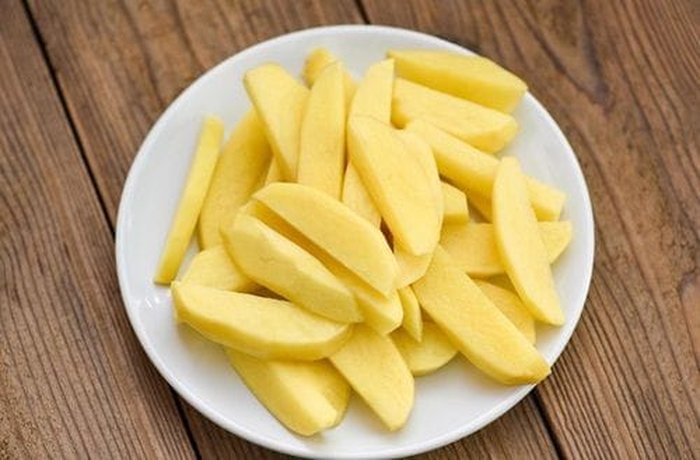 Peeled potato wedges to roast under the chicken